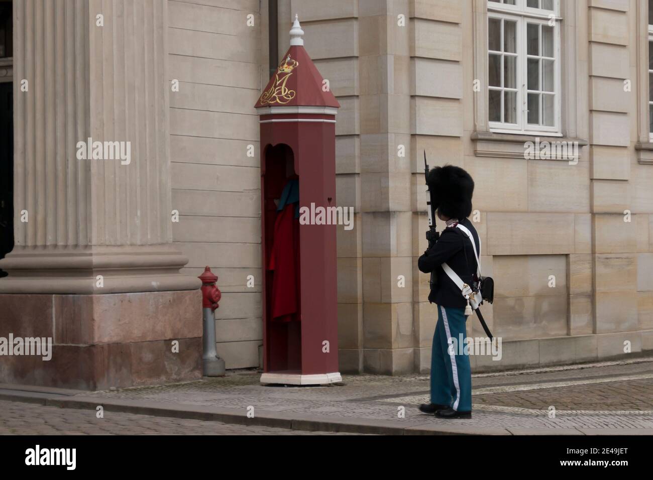 Copenhagen, Denmark - 12 Dec 2020: Members of Danish Royal Life guards marching in front of the Amalienborg Palace, home of the Danish royal family, d Stock Photo