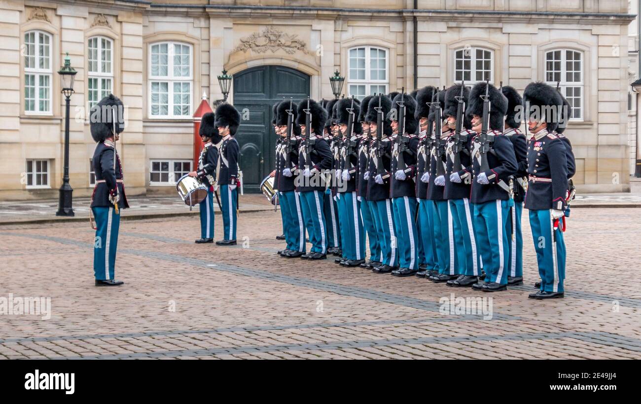 Copenhagen, Denmark - 12 Dec 2020: Members of Danish Royal Life guards marching in front of the Amalienborg Palace, home of the Danish royal family, d Stock Photo