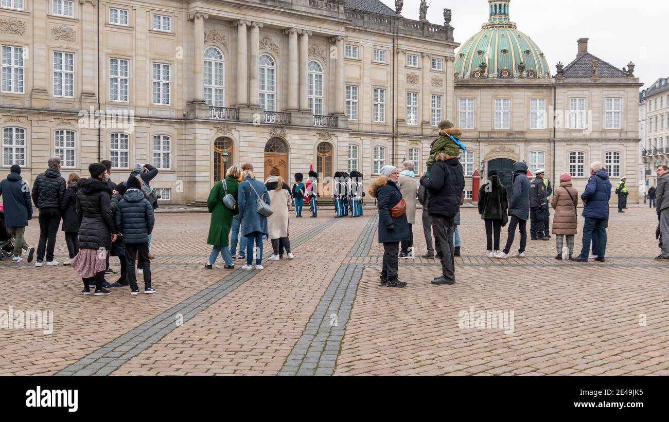 Copenhagen, Denmark - 12 Dec 2020: People looking at members of Danish Royal Life guards marching in front of the Amalienborg Palace, home of the Dani Stock Photo