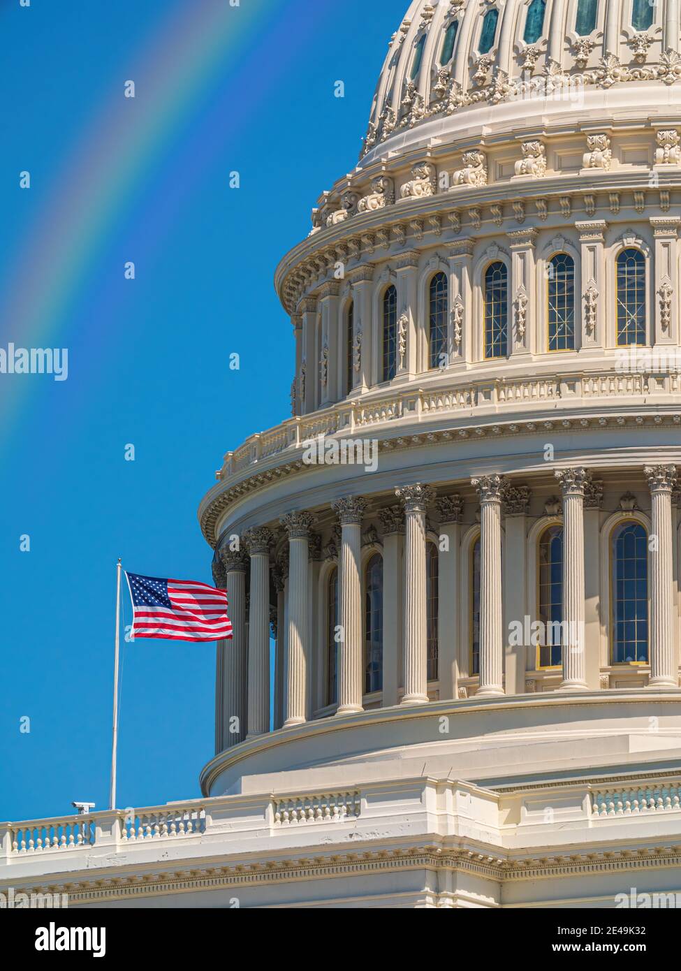 West side view of the United States Capitol building under a rainbow, Washington - USA Stock Photo