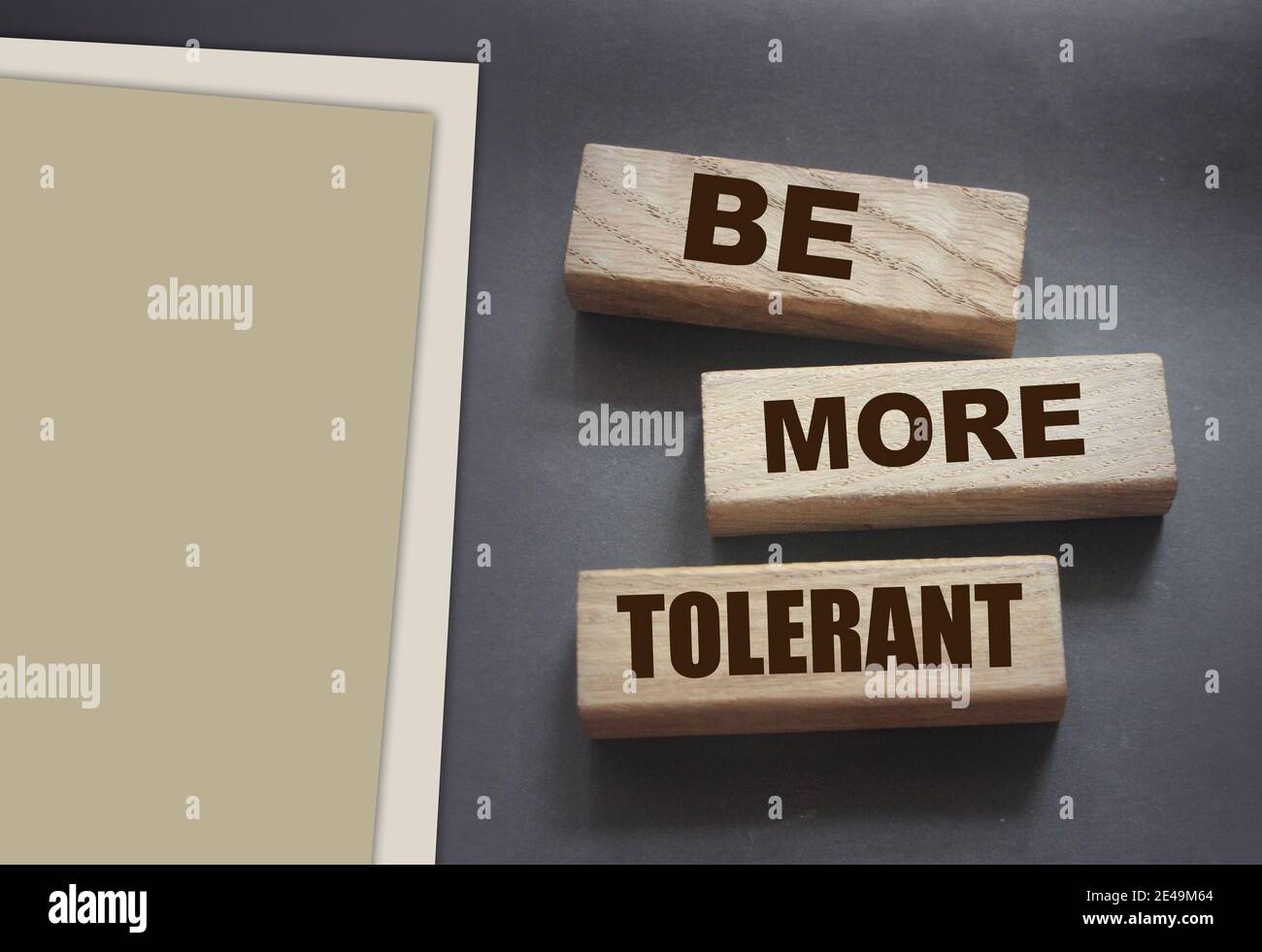 Be More Tolerant words on wooden blocks on dark background. Tolerance Equality diversity social concept. Stock Photo