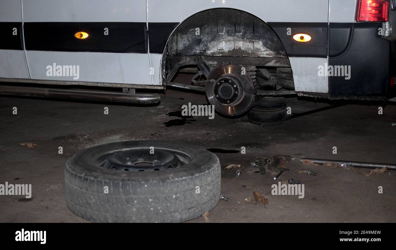 Car under repair, tire fitting, car dismantling, disc brakes Stock