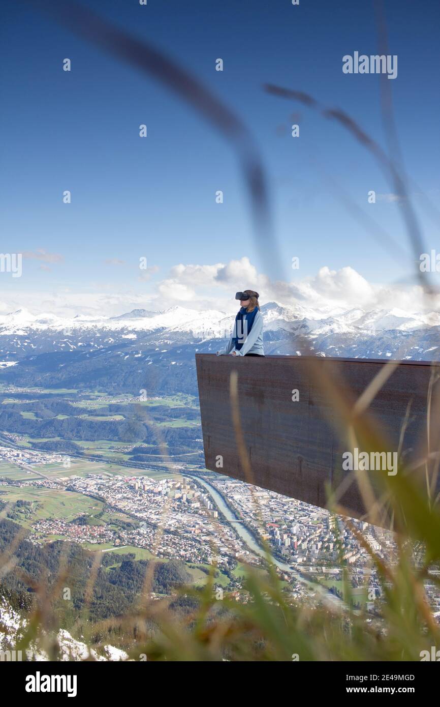 Person mit Virtual-Reality-Brille vor Bergkulisse Stock Photo