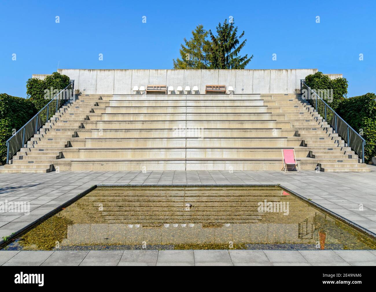 water basin and steep spectator stand made from concrete in the open with blue sky at Mistelbach, Austria Stock Photo