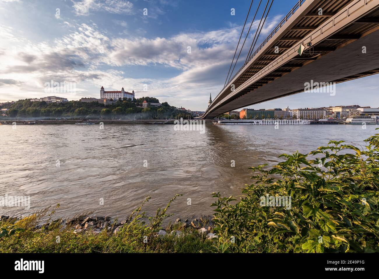 Beach of Danube River with bridge leading to Bratislava Castle, Slovakia, Europe Stock Photo