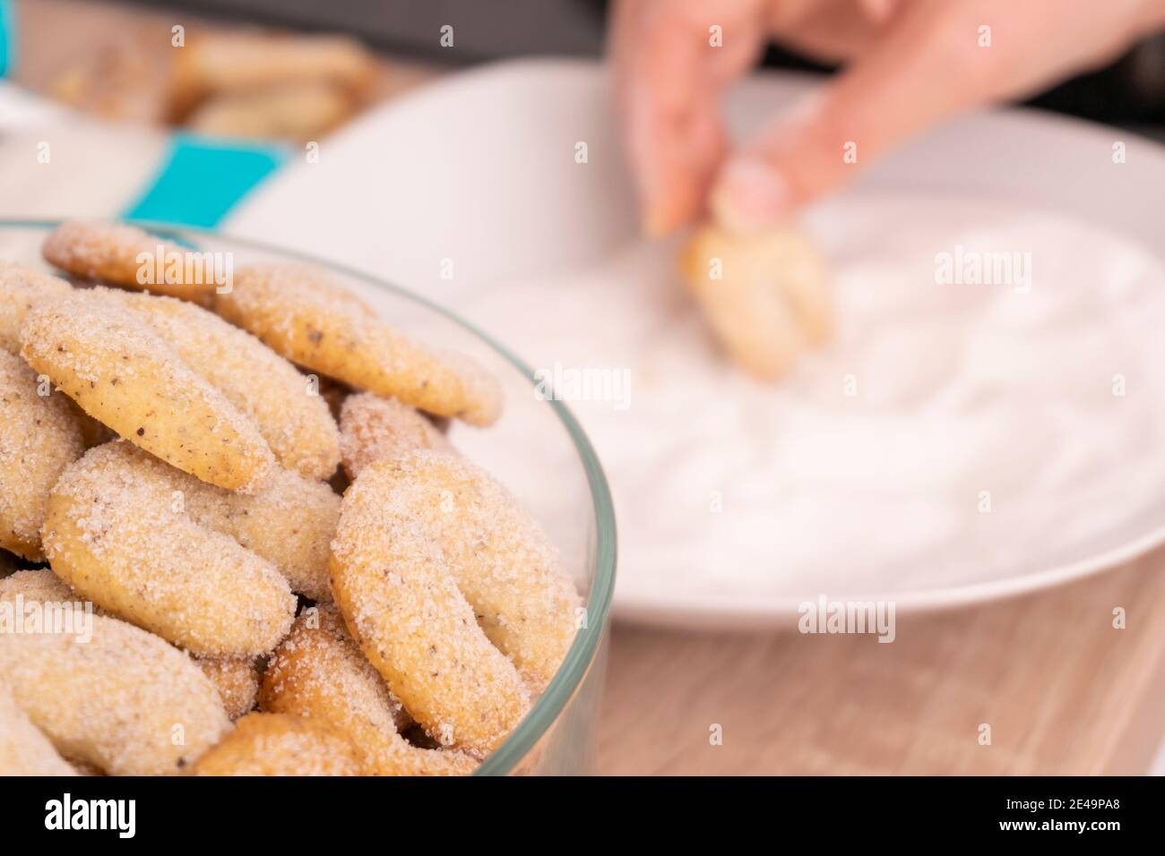 Young Woman making german christmas bakery at home in kitchen Stock Photo