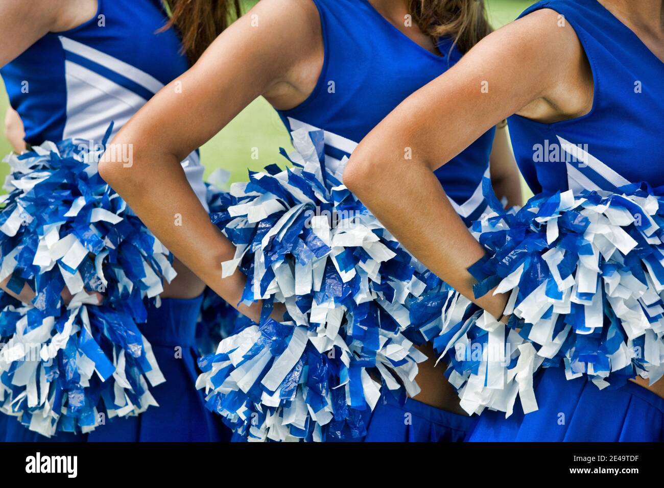 Cheerleaders in Uniform Holding Pom-Poms Stock Photo - Alamy