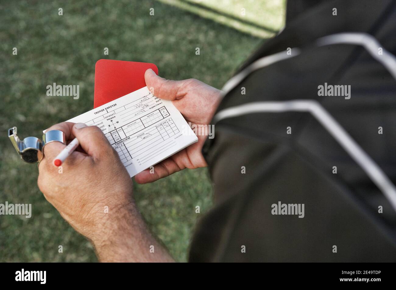 Photo of referee writing report Stock Photo Alamy