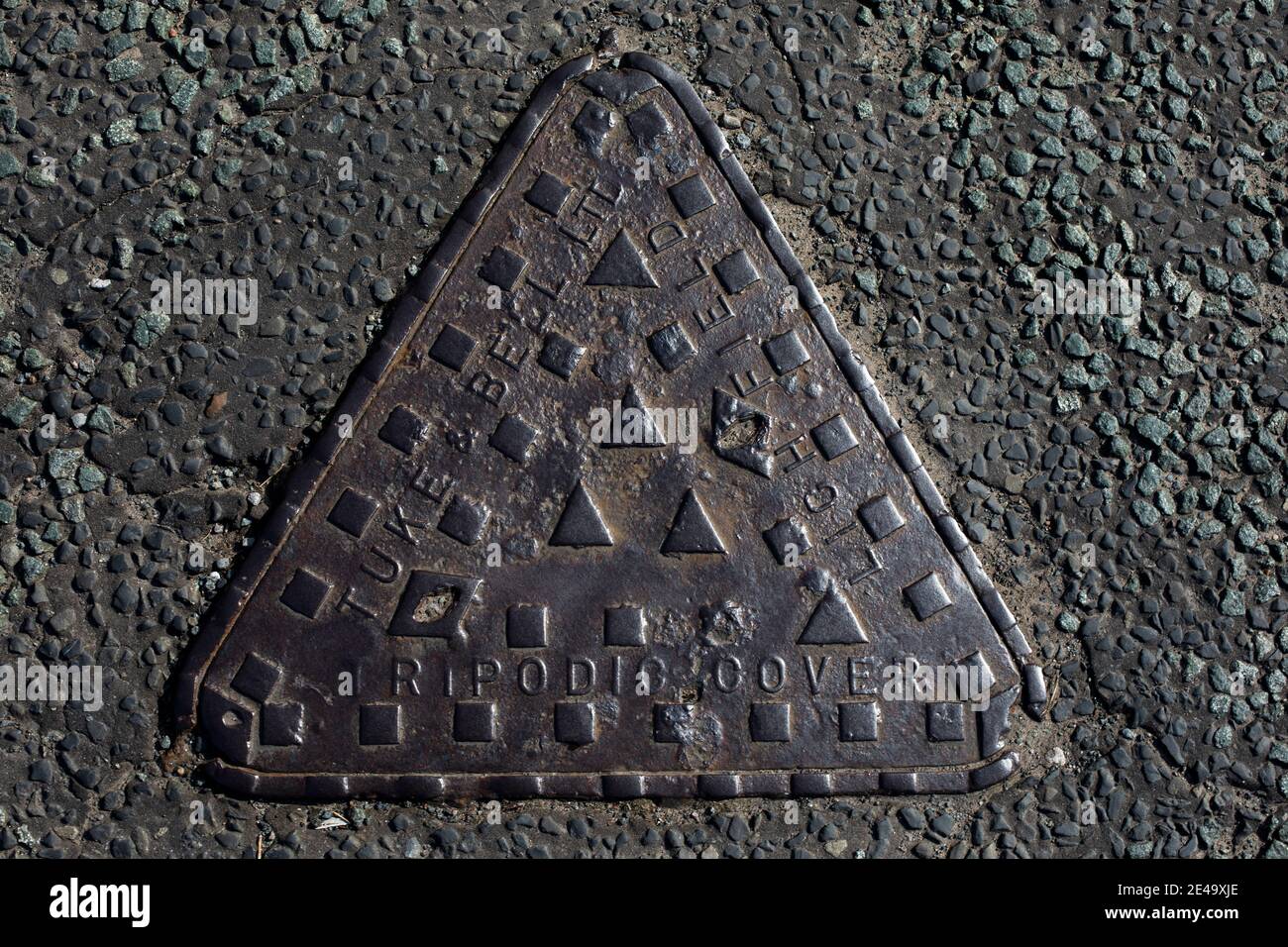A man hole pictured on a street in Wirral, England. Stock Photo