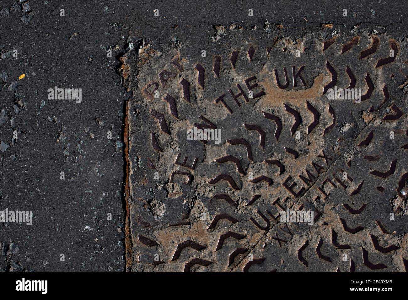 A man hole pictured on a street in Wirral, England. Stock Photo