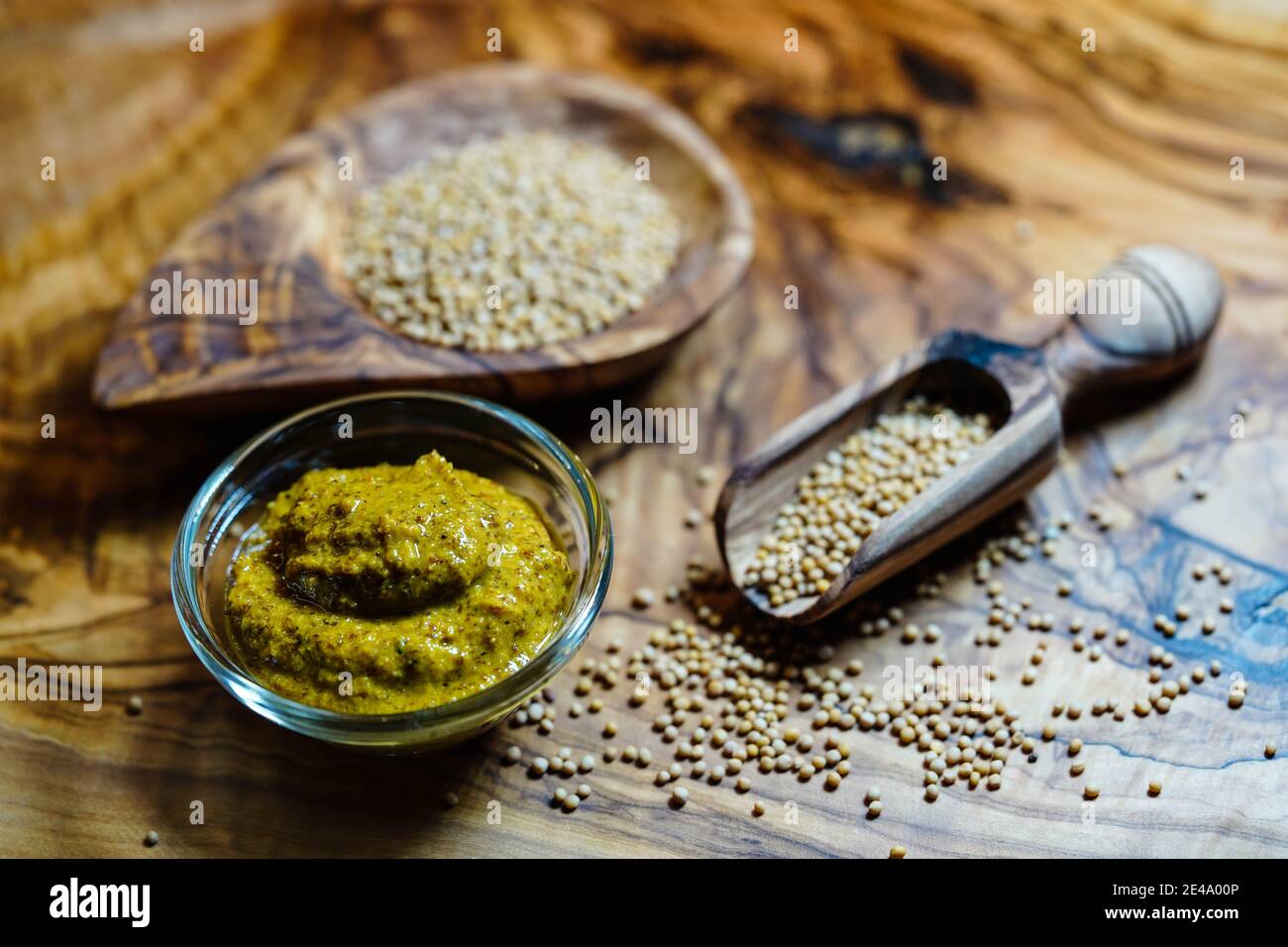 Mustard seeds granum sinapis and a wooden spoon Stock Photo Alamy