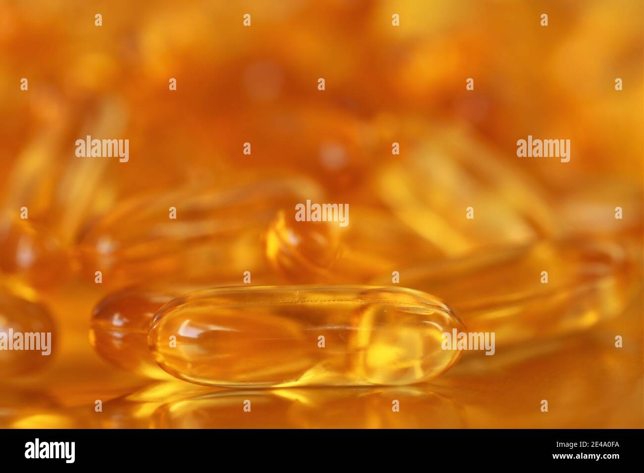 fish oil capsules close-up heap on gold background.Fish oil in gelatin