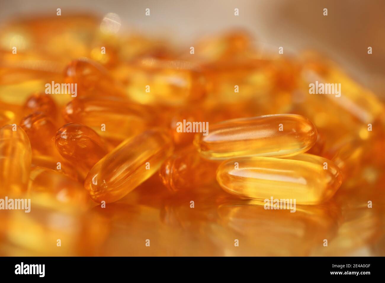 fish oil capsules closeup heap on blurred gold background.Fish oil in