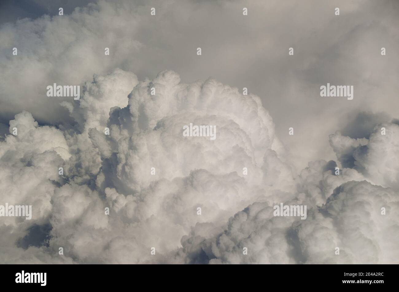large dense white clouds in the sky view from airplane Stock Photo
