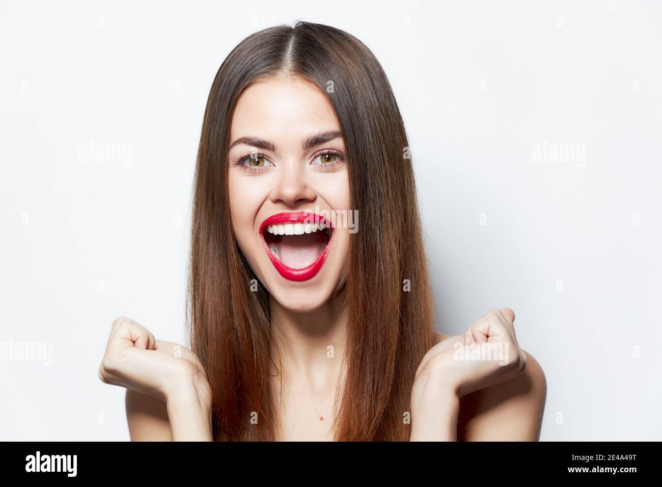 Woman portrait laughs clenched her hands into a fist attractive look Stock Photo Alamy