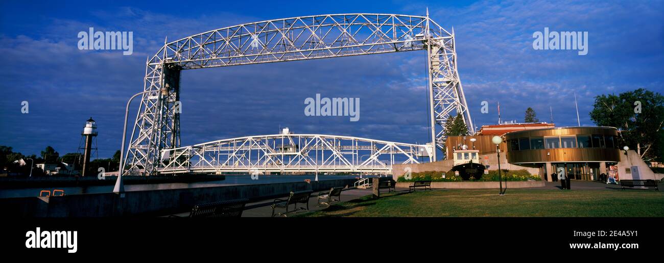 Bridge across a lake at dusk, Aerial Lift Bridge, Lake Avenue, Duluth, Minnesota, USA Stock Photo