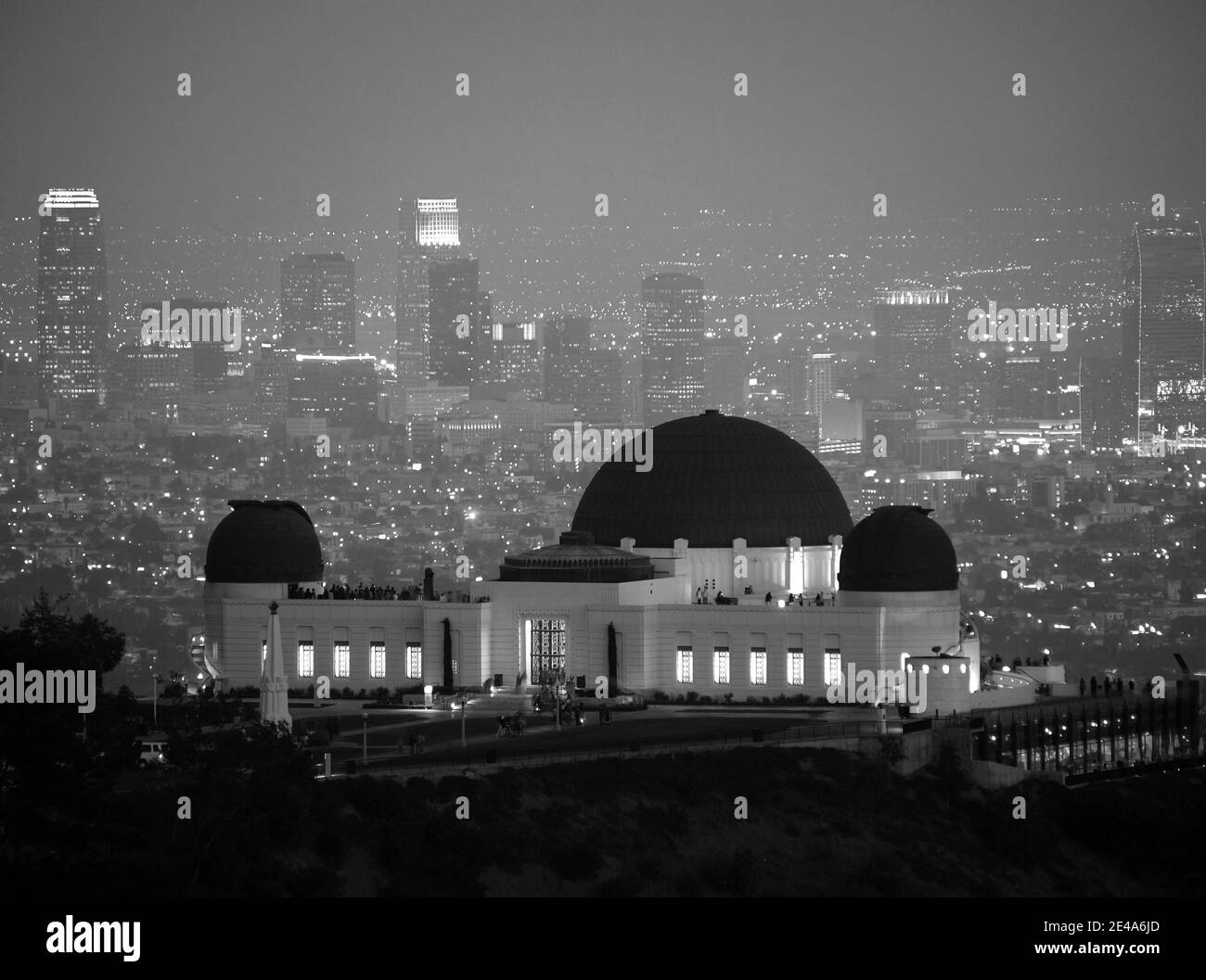 Foggy downtown night skyline behind Los Angeles's city owned Griffith Park Observatory. Stock Photo
