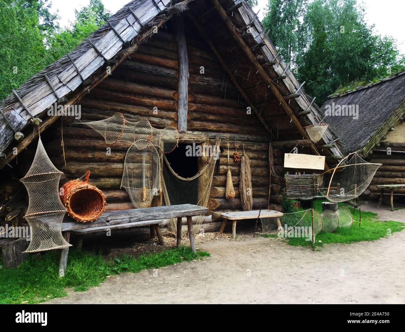 A replica of a historic fisherman's house with drying nets in front of the entrance. Stock Photo