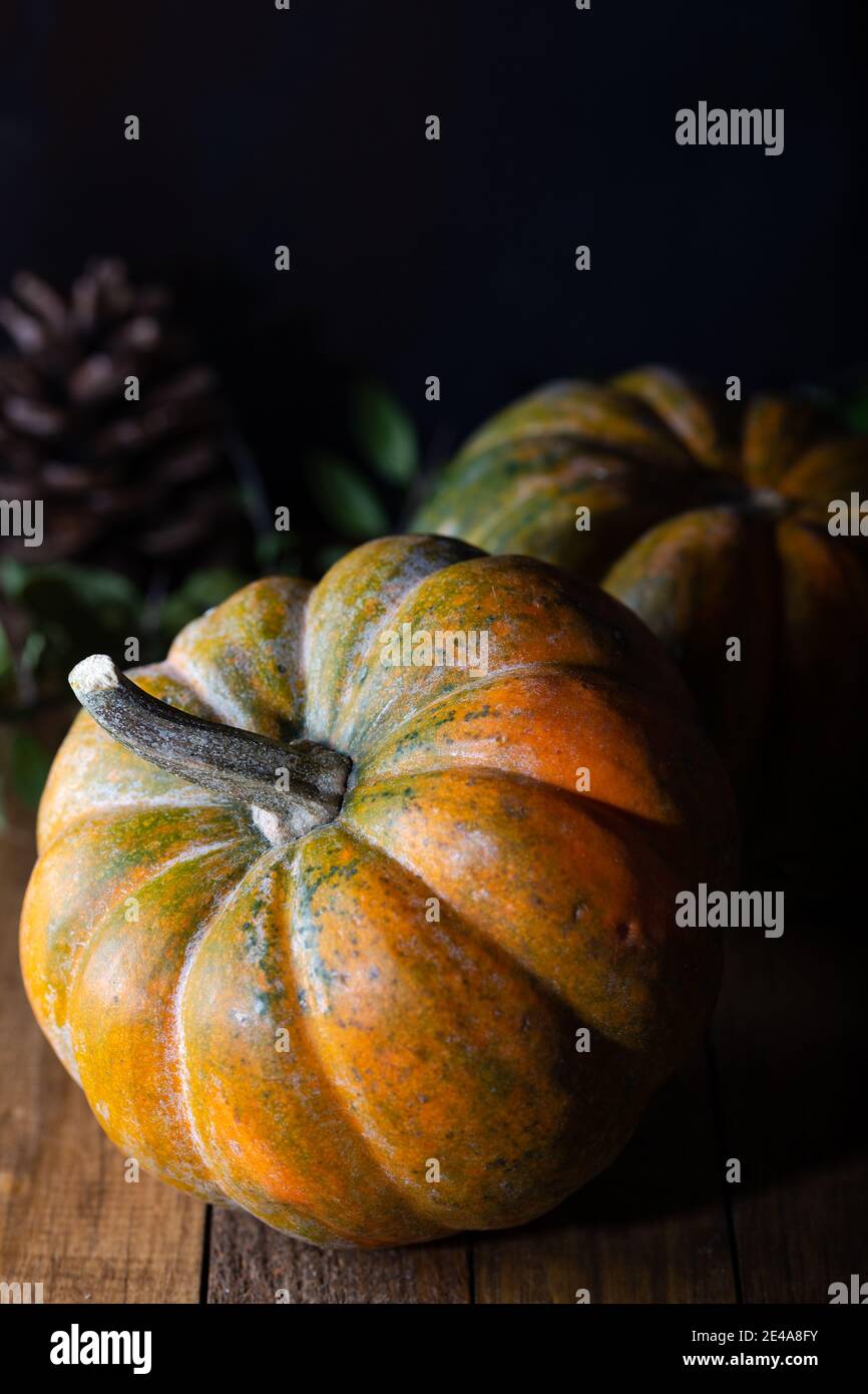 Fresh pumpkins on a wooden dark vintage table, banner. Food background. Thanksgiving and halloween holiday concept. Stock Photo