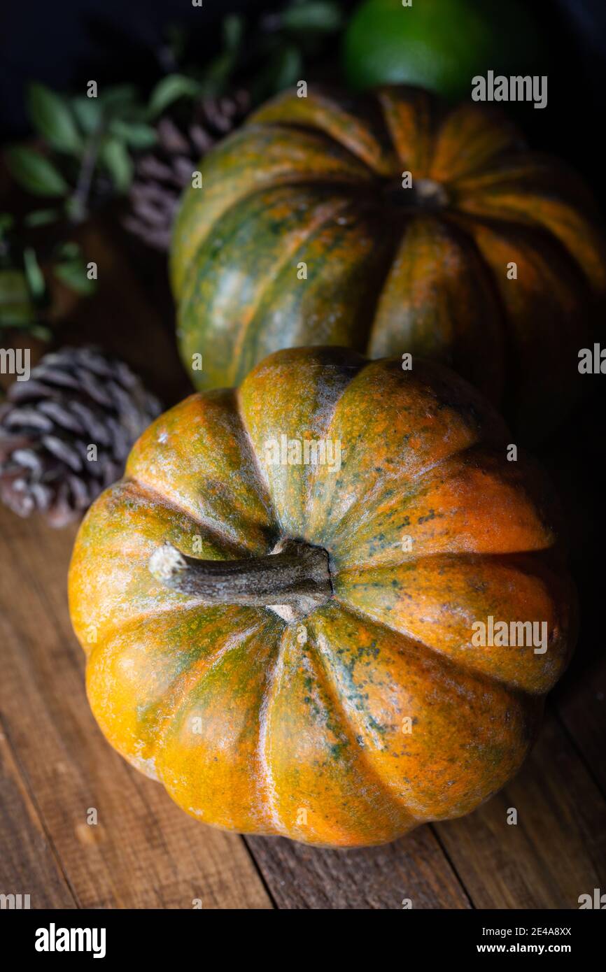 Fresh pumpkins on a wooden dark vintage table, banner. Food background. Thanksgiving and halloween holiday concept. Stock Photo
