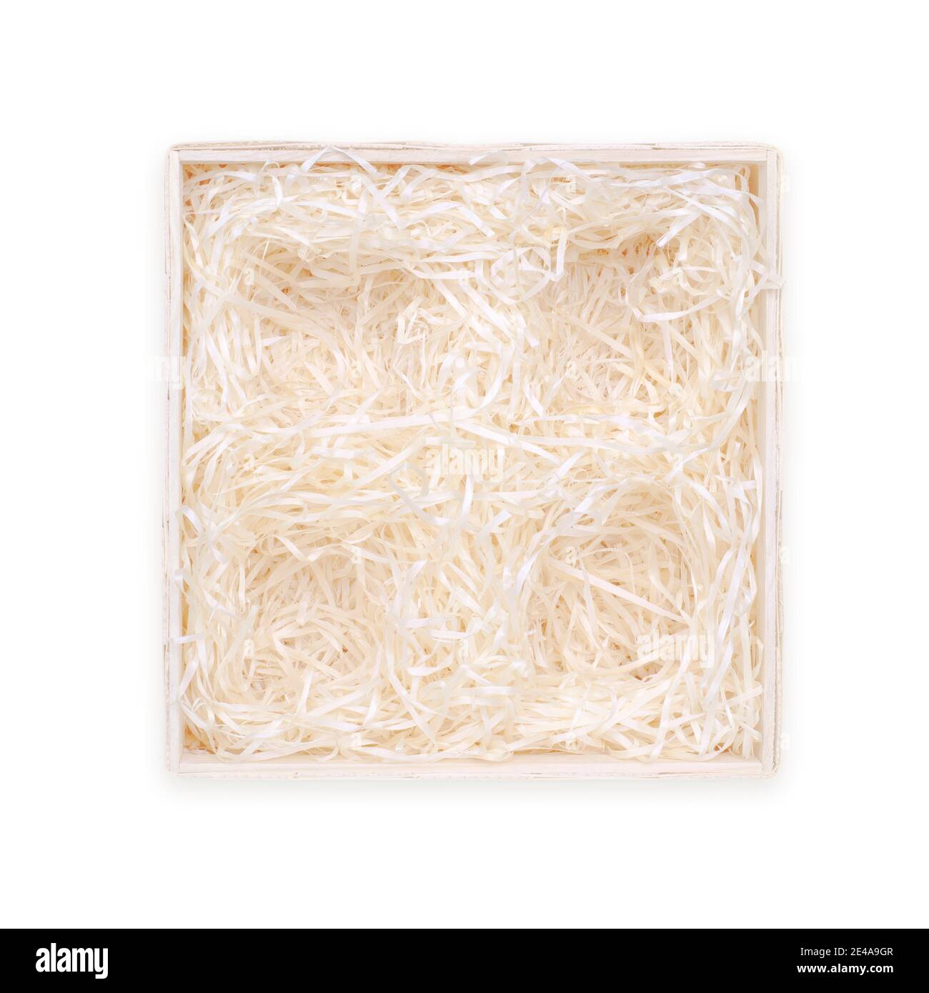 Top view of wooden box for eco gift filled with decorative shredded white paper with four holes for gifts. Isolated on white, clipping path included. Stock Photo