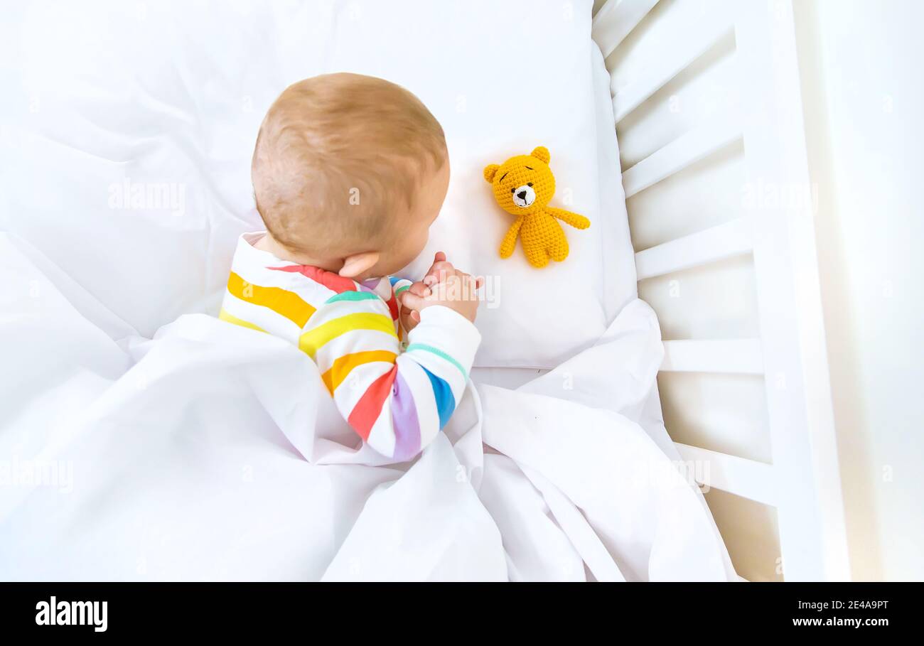 The baby in the crib goes to bed. Selective focus. People Stock Photo