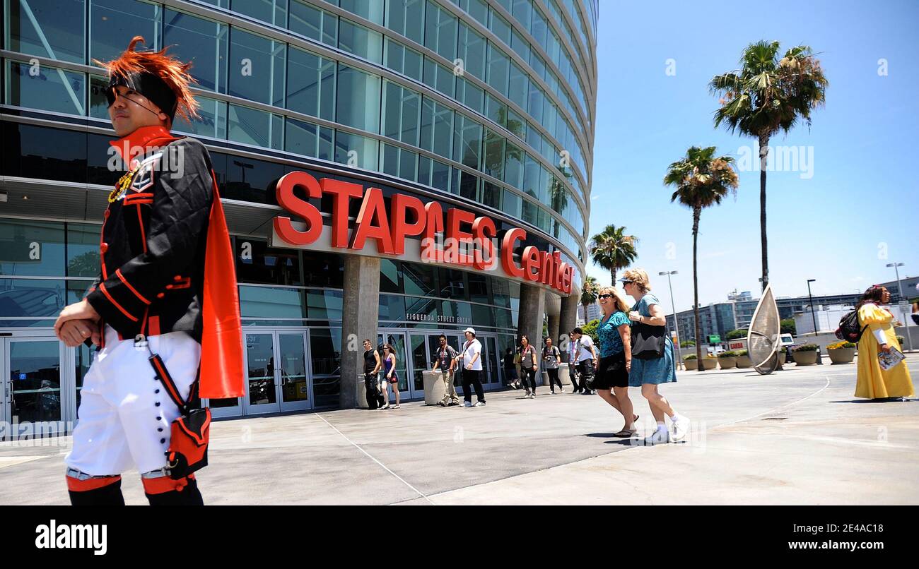 Pedestrians dressed for the Anime Expo being held at a convention hall,  walk past the Staples Center on July 2, 2009 in Los Angeles, California.  According to reports, a public tribute to