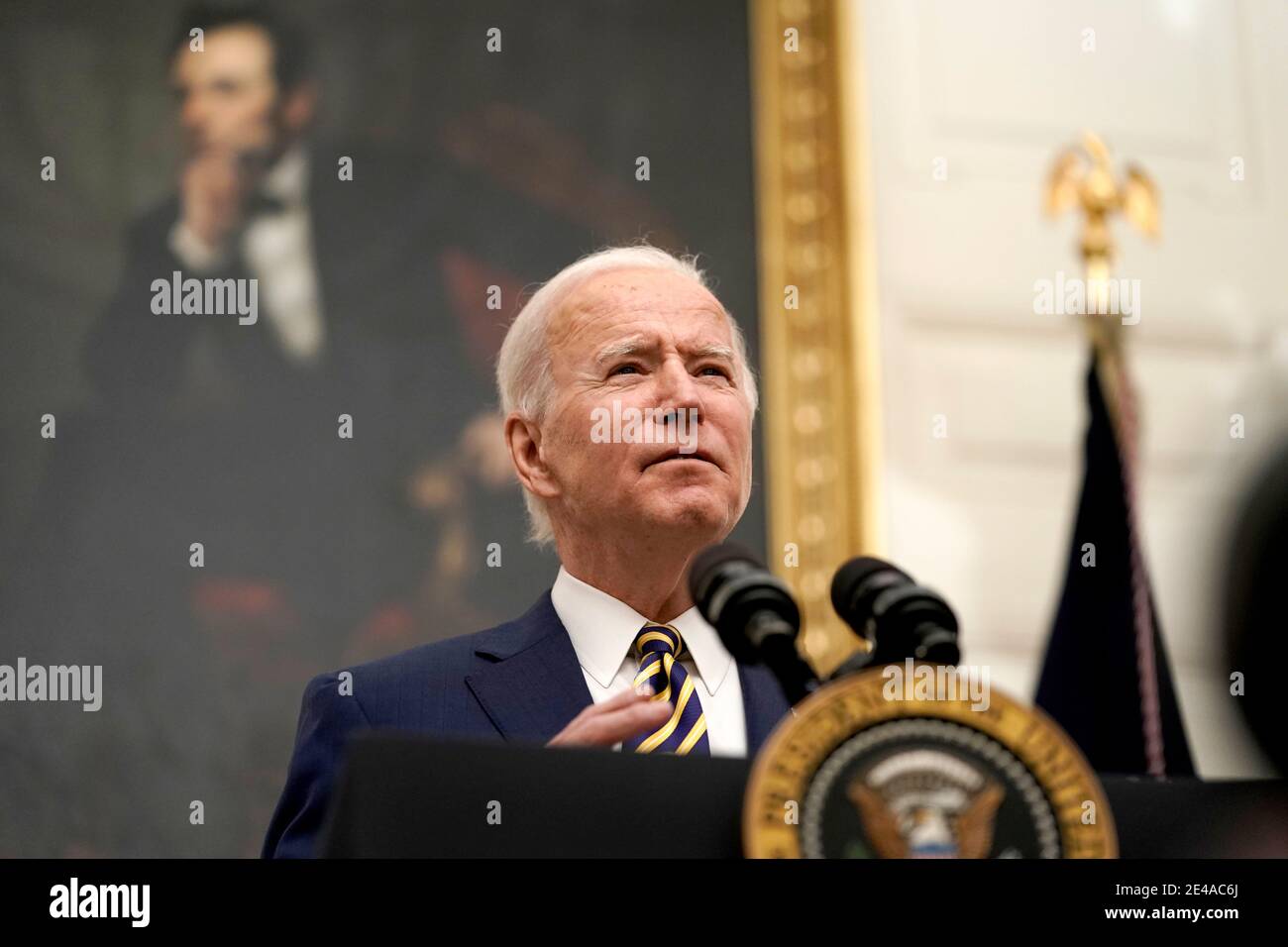 United States President Joe Biden delivers remarks on his administration's response to the economic crisis and signs executive orders in the State Dining Room of the White House in Washington, DC on Friday, January 22, 2021.Credit: Ken Cedeno/Pool via CNP | usage worldwide Stock Photo