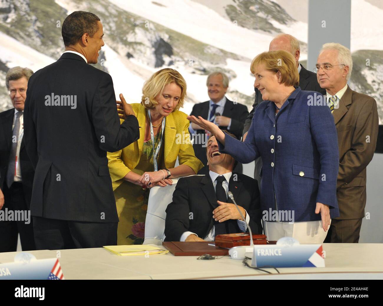 US President Barack Obama speaks with French President Nicolas Sarkozy (with interpreter Amanda Galsworthy) and German Chancellor Angela Merkel before a round-table discussion with the leaders of the G8 group of nations during their summit at the Guardia Di Finanza School of Coppito in L'Aquila, Italy, on July 8, 2009. Photo by Elodie Gregoire/ABACAPRESS.COM Stock Photo