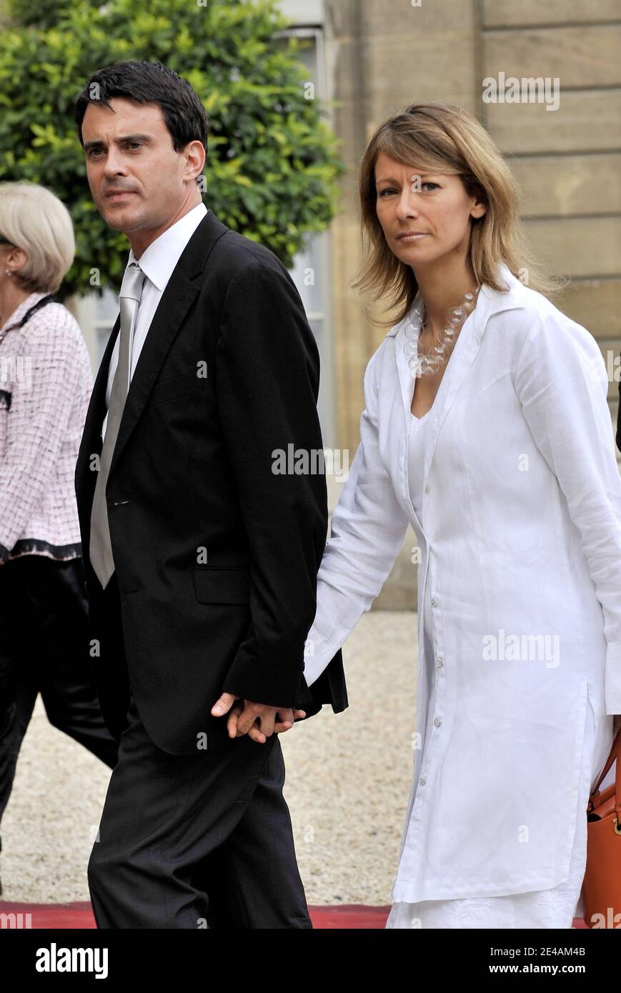 Manuel Valls and his companion Anne Gravoin arrive for the Garden Party at Elysee Palace in Paris, France on July 14, 2009. Photo by Christophe Guibbaud/ABACAPRESS.COM Stock Photo
