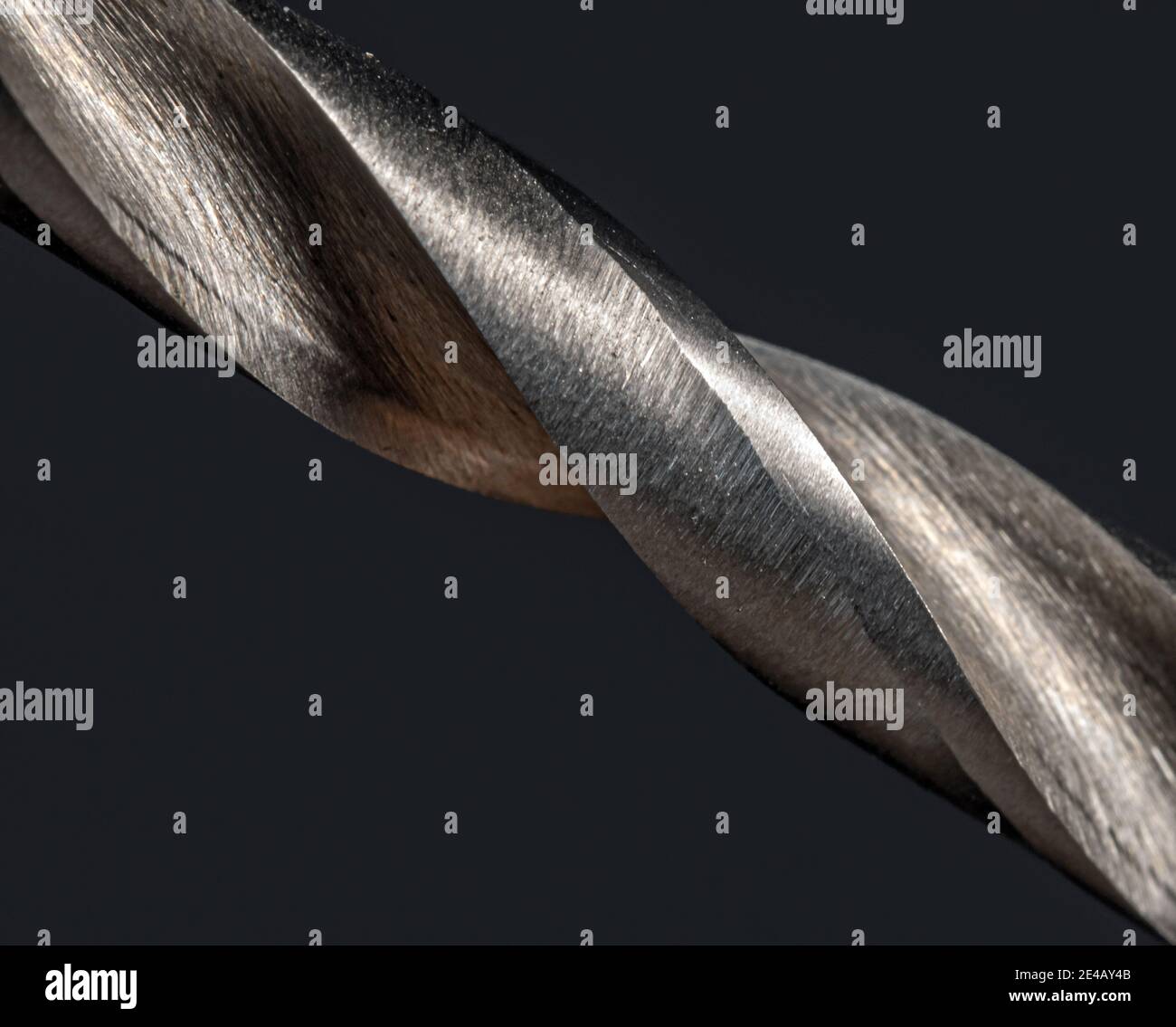 Sharp cuts of screwthreads on a metal drill, macro view. Structure of