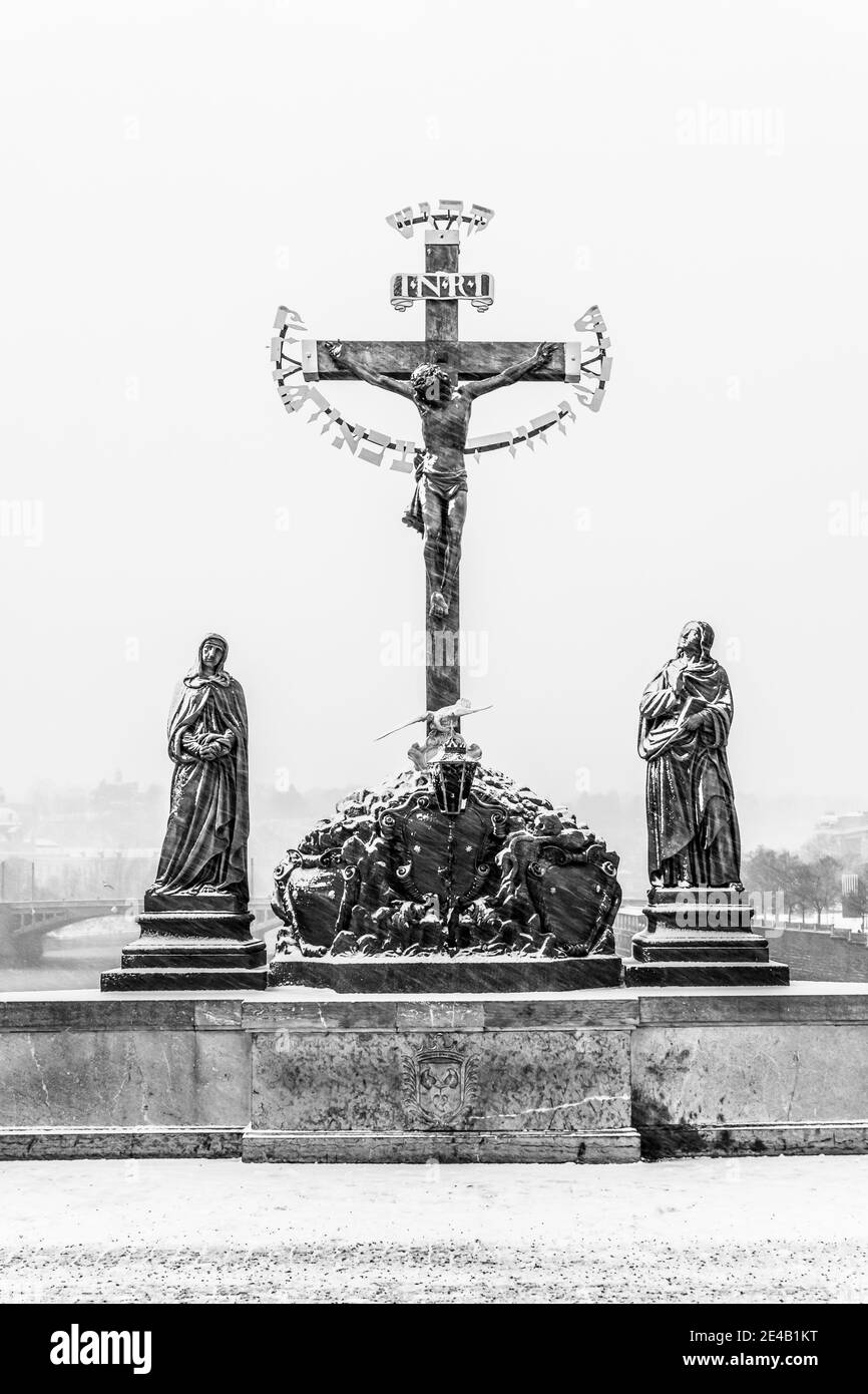 Crucifix statue on Charles Bridge in Prague Stock Photo
