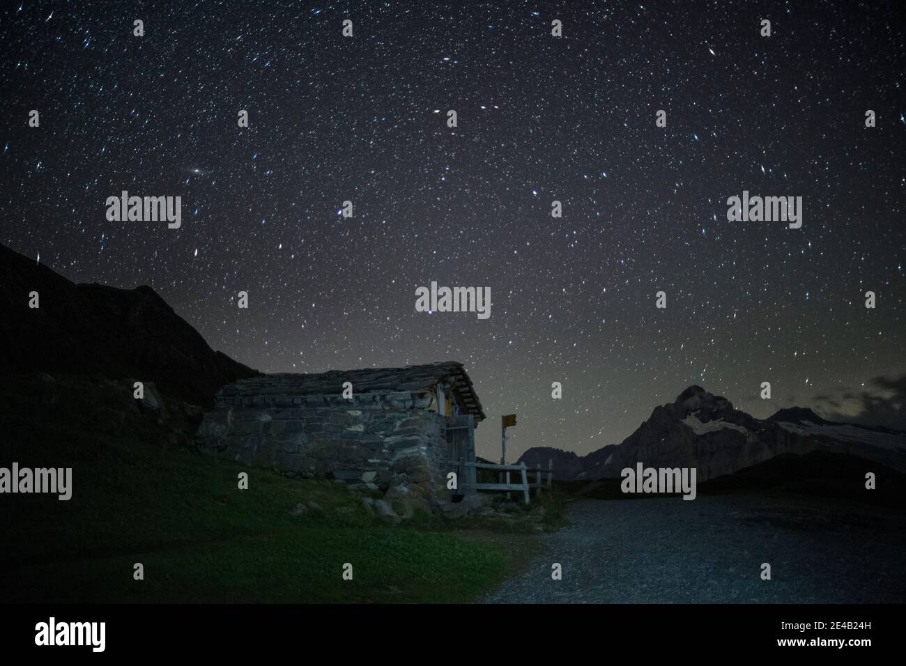 Night, starry sky, hiking trail with hut and signpost Stock Photo