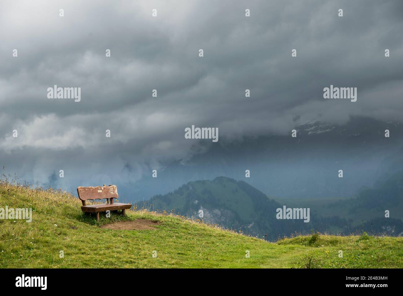 abandoned, single bench in rainy weather Stock Photo
