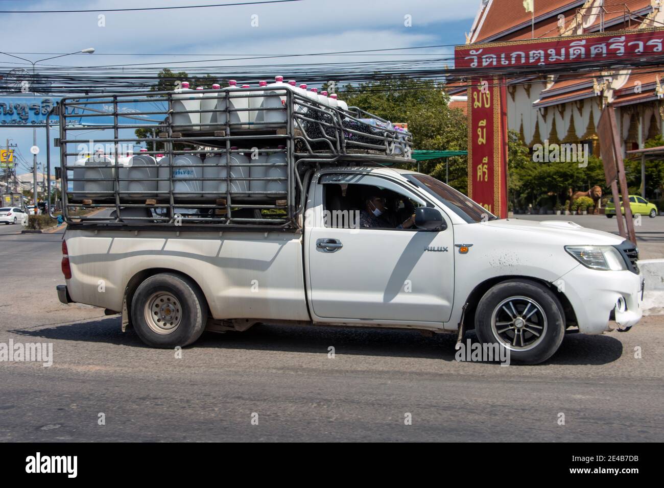 BANGKOK, THAILAND, JULY 18 2020, A pick up loaded with containers for drinks ride on the city streets. Stock Photo