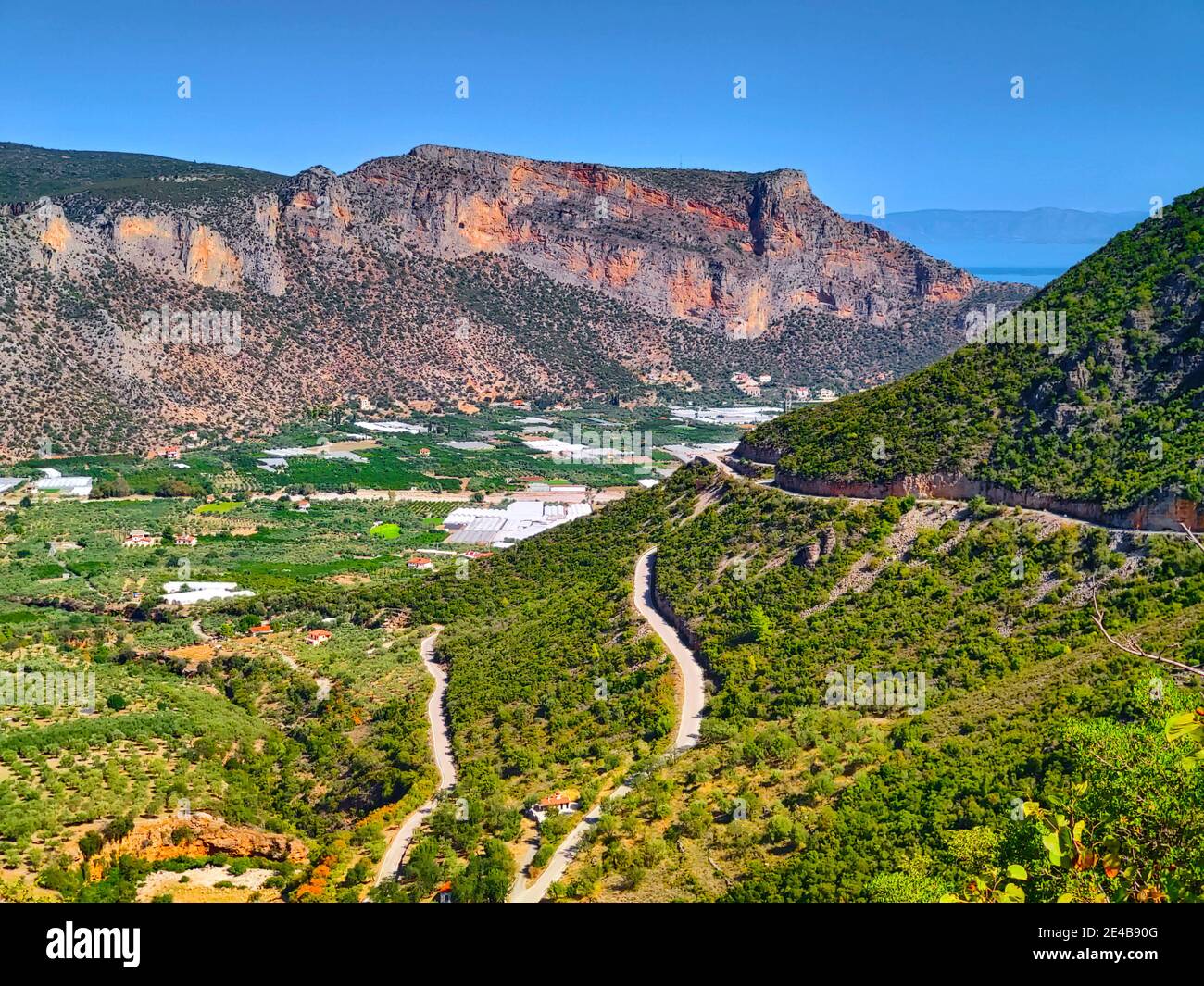 View from a mountain road to the fertile estuary of the Daphnon, vegetable and fruit-growing area of Leonidion, Arcadia, Peloponnese, Greece Stock Photo