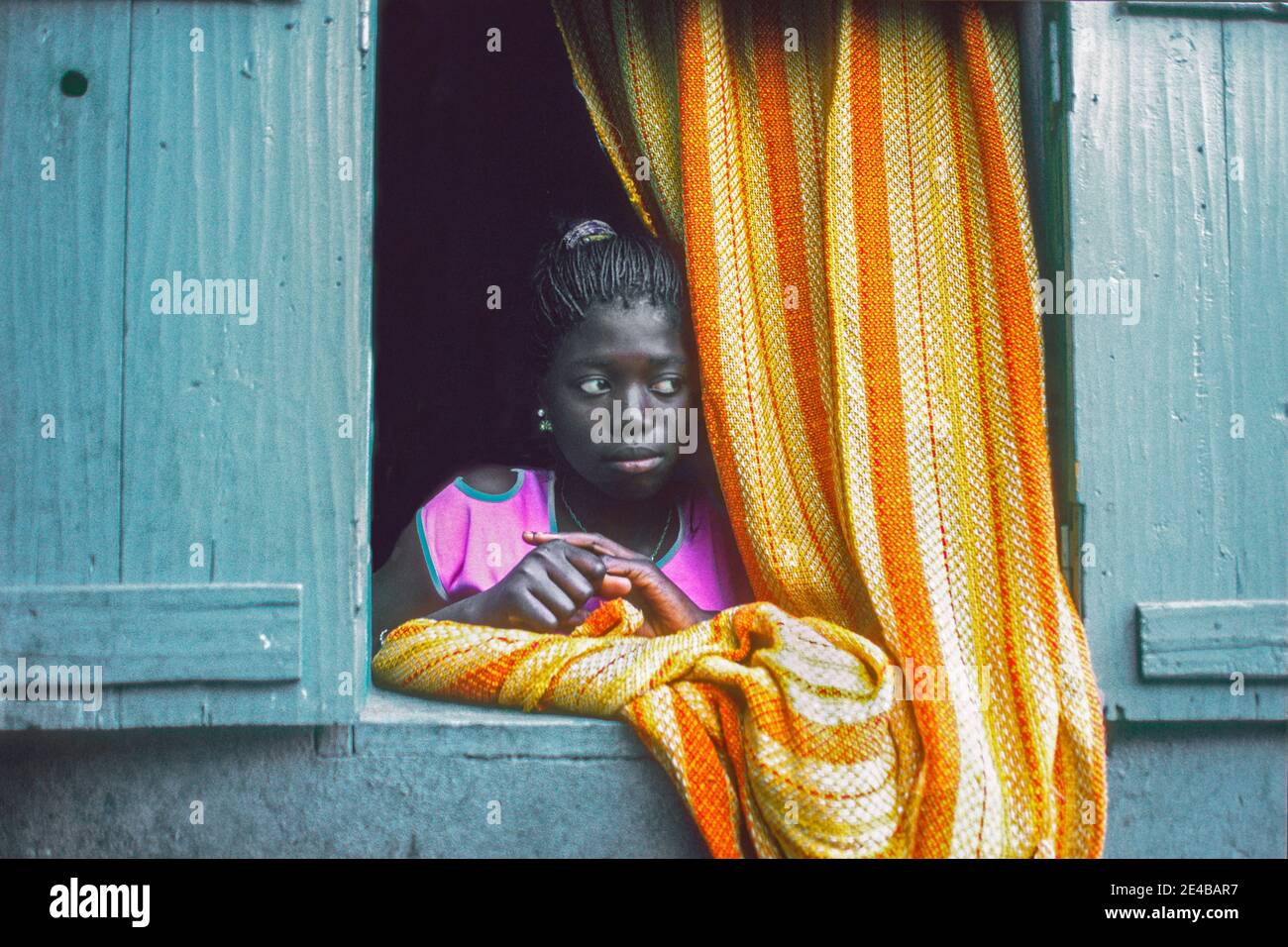Girl in window Dakar Senegal West Africa Stock Photo