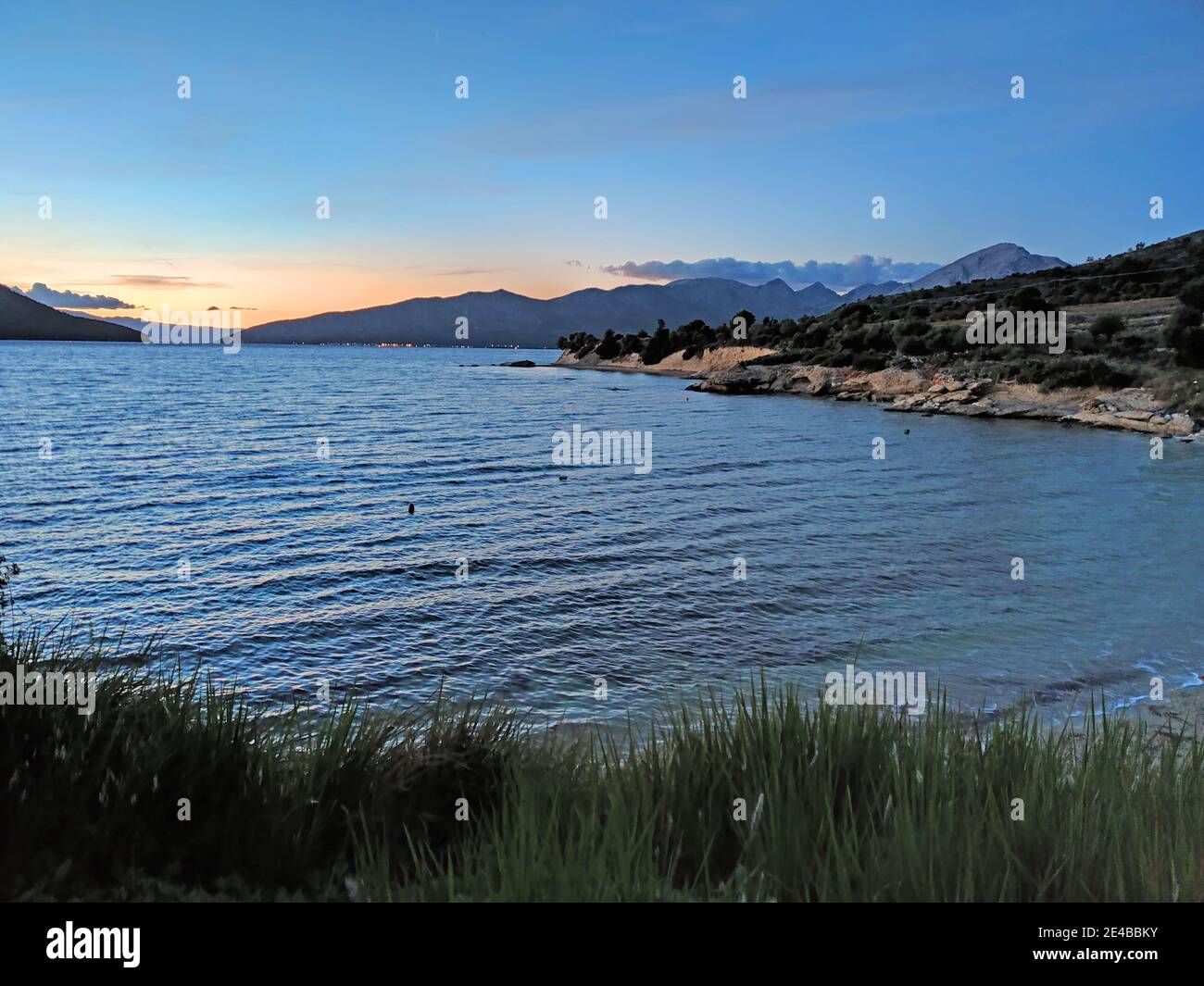 Bay on the mainland in the sound of Kalamos island, Ionian Sea, central Greece Stock Photo