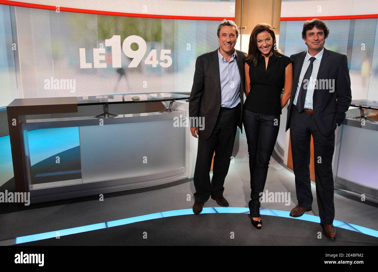 TV Anchor and journalist Claire Barsacq (C), Jerome Bureau (L) and Vincent  Regnier (R) from M6 pose after the evening news program, in Neuilly sur  Seine, France, on September 7, 2009. Photo