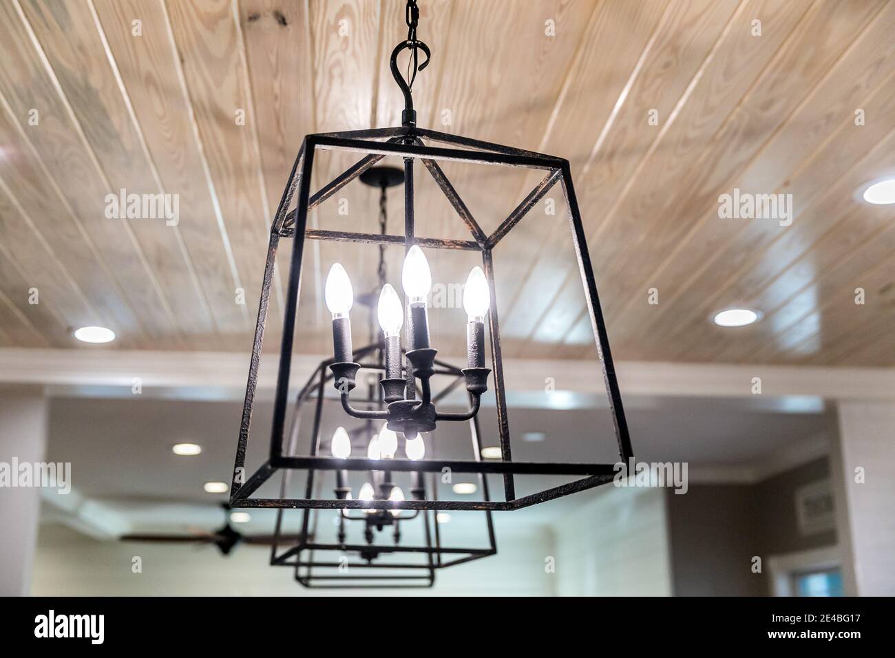 Hanging black metal iron lighting fixtures in a newly renovated kitchen Stock Photo