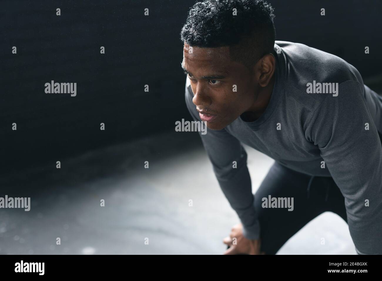 Portrait of african american man standing in an empty urban building and resting Stock Photo