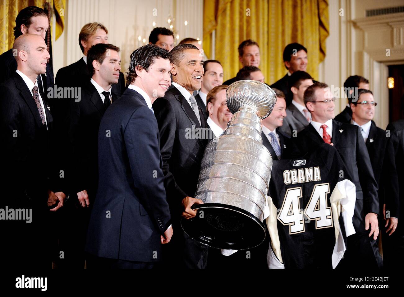President Barack Obama receives a jersey from the Pittsburgh Penguins  during a ceremony to honor them for their 2009 Stanley Cup championship  victory on September 10, 2009 in Washington, DC, USA on
