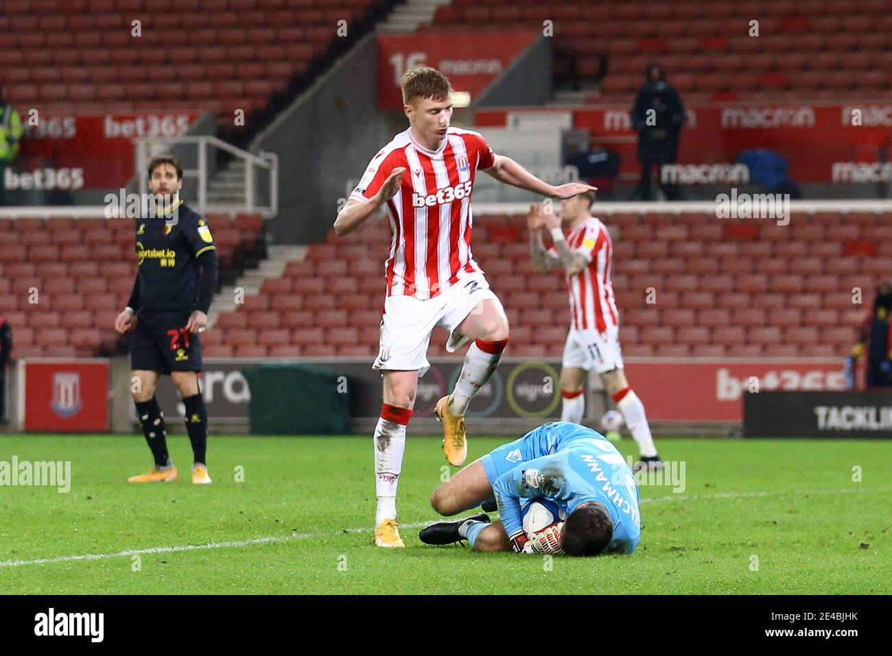 Stoke On Trent, UK. 22nd Jan, 2021. Watford Goalkeeper Daniel Bachmann gets to the ball just ahead of Sam Clucas of Stoke City. EFL Skybet Championship match, Stoke City v Watford at the Bet365 Stadium in Stoke on Trent on Friday 22nd January 2021. this image may only be used for Editorial purposes. Editorial use only, license required for commercial use. No use in betting, games or a single club/league/player publications.pic by Chris Stading/Andrew Orchard sports photography/Alamy Live News Credit: Andrew Orchard sports photography/Alamy Live News Stock Photo