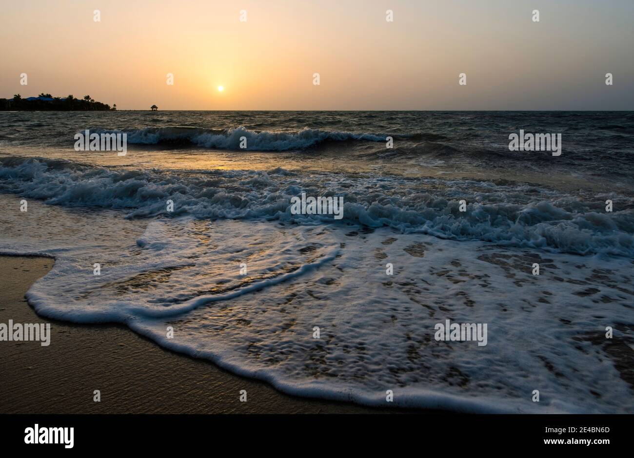 Waves on the beach at sunrise, Placencia, Stann Creek District, Belize Stock Photo