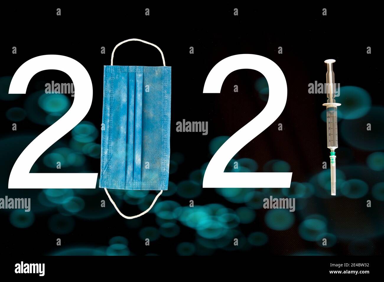 The number 2021 written with mask, number and syringe. A design considered due to Covid-19. Different symbols in the background. 2021 year themed. Stock Photo