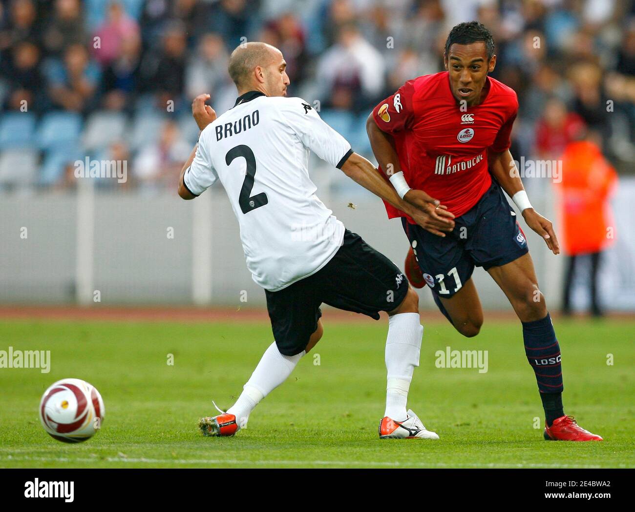 Lille's Pierre-Emerick Aubameyang fights for the ball with Valence's Bruno Saltore during the europa league soccer match between french team Lille (LOSC) and spanish team Valence CF at Lille Metropole Stadium in Lille, France on September 17, 2009. The ma Stock Photo