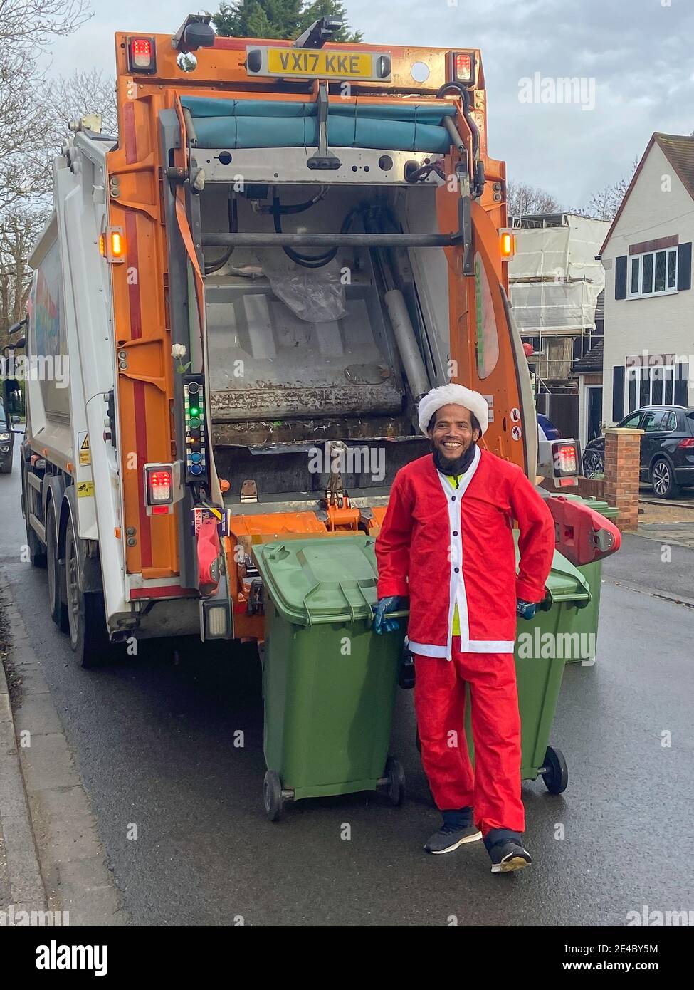 Council rubbish collector wearing Christmas outfit, Stanwell Moor,  Surrey, England, United Kingdom Stock Photo