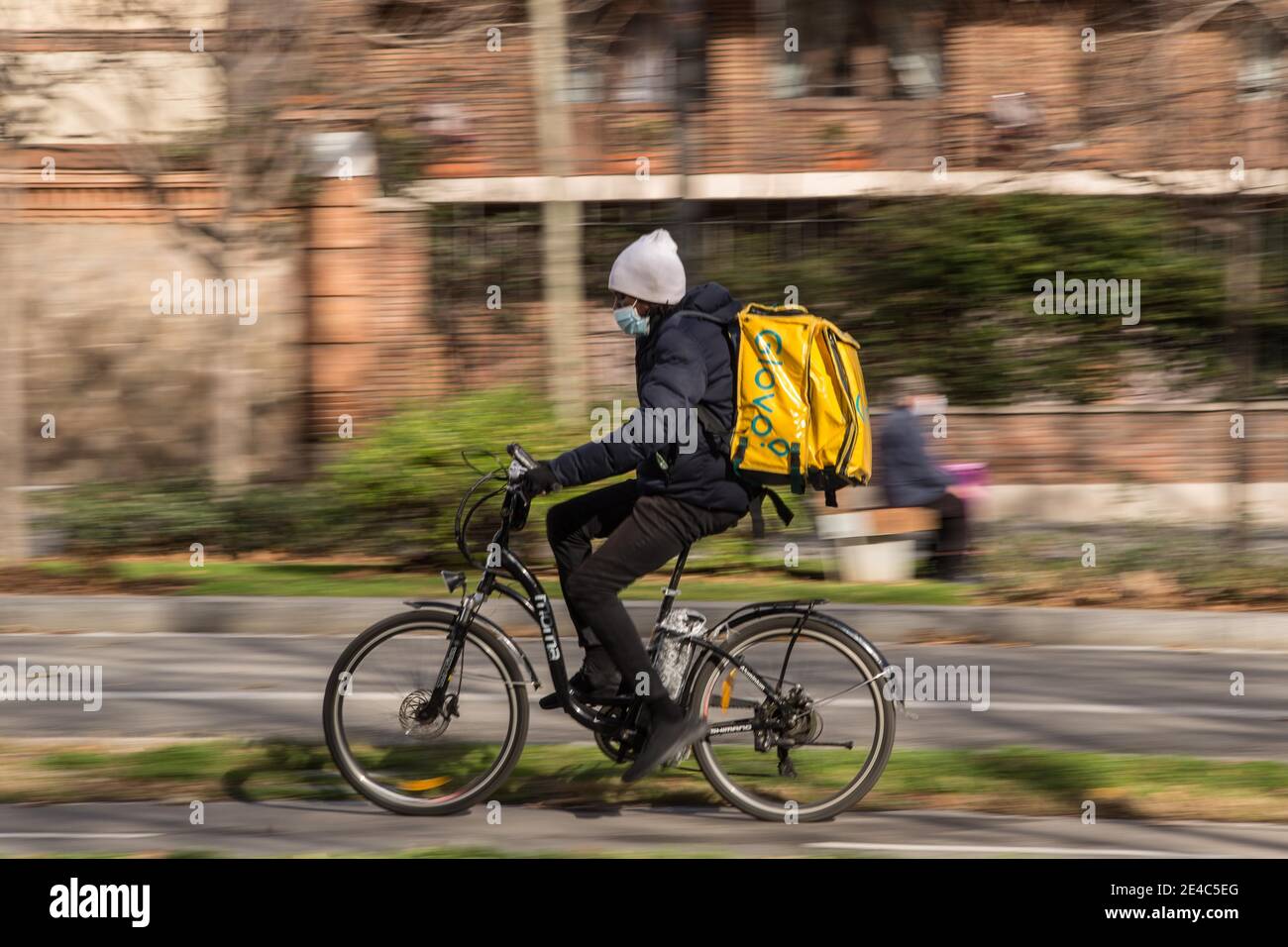 Barcelona, Catalonia, Spain. 22nd Jan, 2021. Glovo app delivery man seen riding a bike.The Ministry of Labor of Spain is developing a legislative framework that encompasses the activity of home delivery people, known as riders, who operate for digital platforms such as Glovo, Deliveroo, Just Eat or Uber Eats. The new Rider Law would oblige companies to hire their workers and thus end the figure of the false self-employed. Credit: Thiago Prudencio/DAX/ZUMA Wire/Alamy Live News Stock Photo