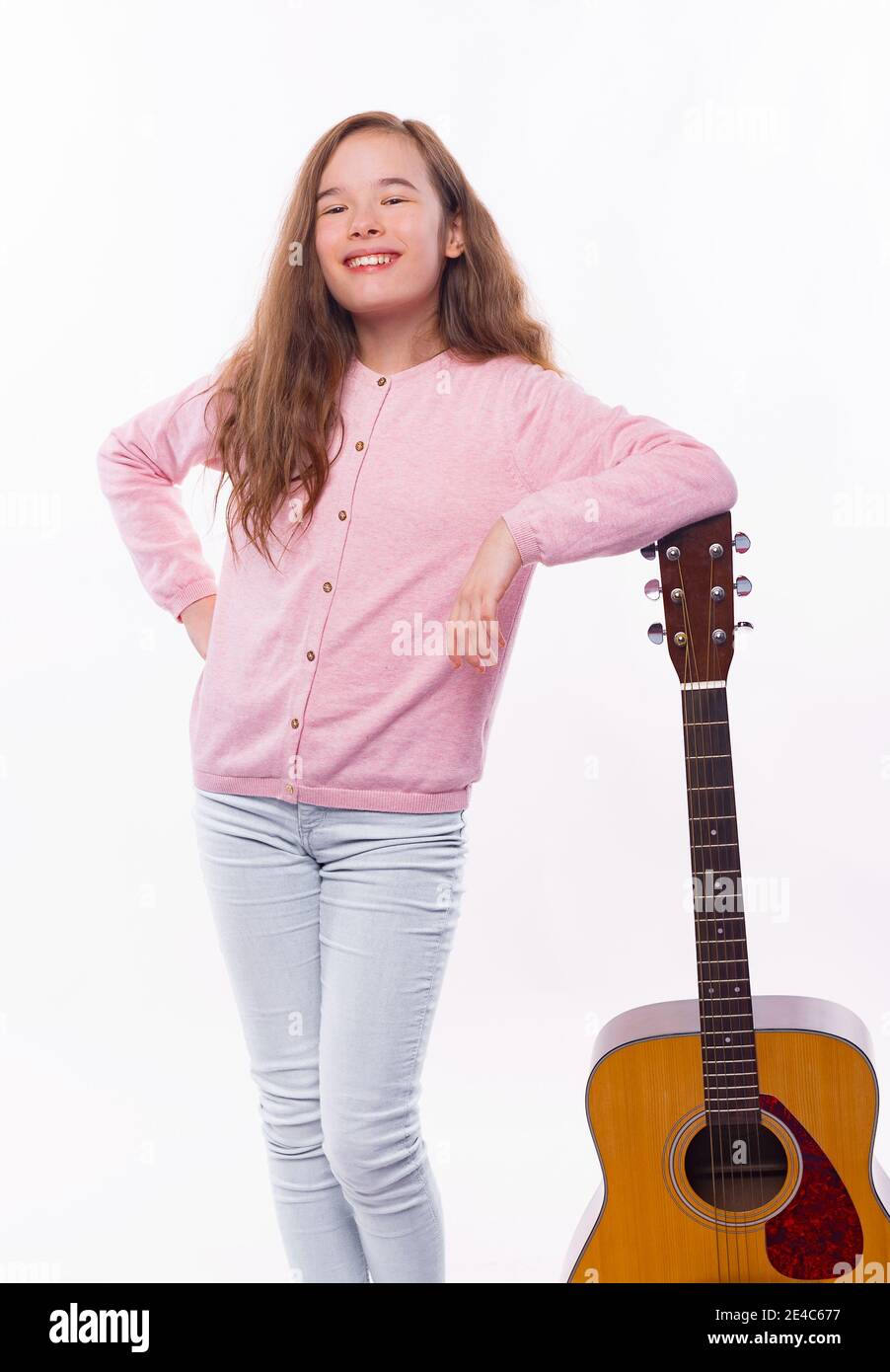 Photo of happy girl holding acoustic guitar over white background Stock ...