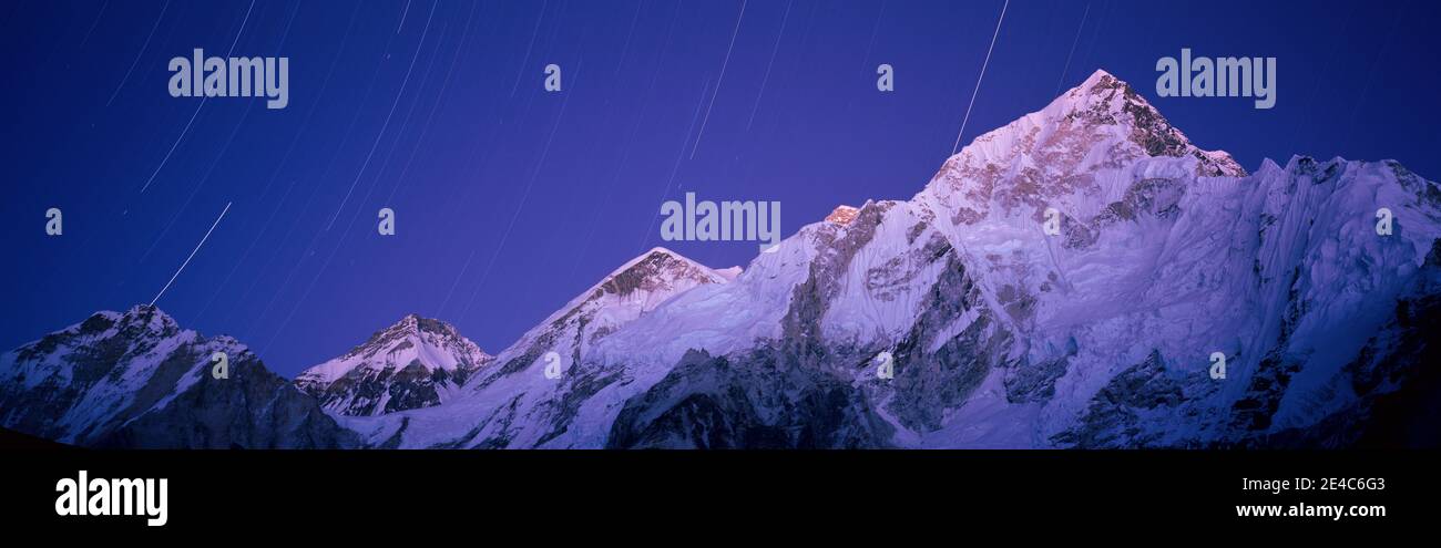 Star trails over snowcapped Nuptse and Mt Everest range, Everest Base Camp Trek, Khumbu, Nepal Stock Photo